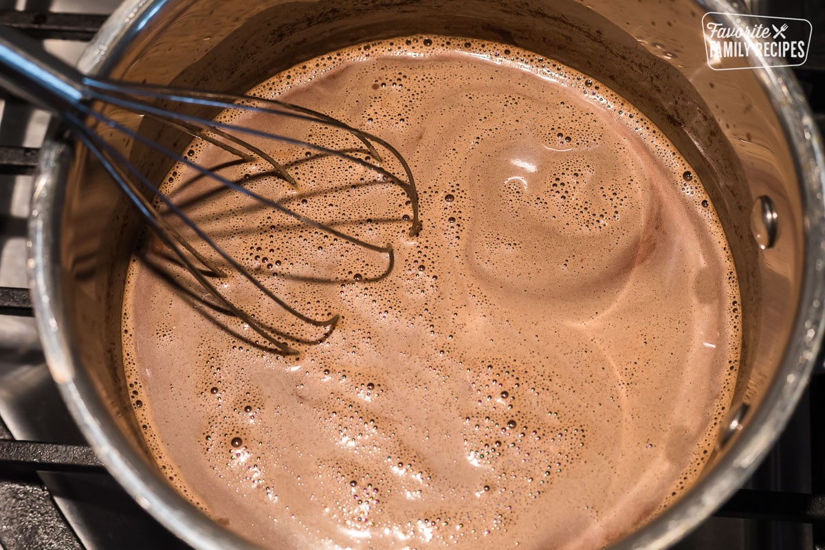 A saucepan with Mexican hot chocolate being whisked