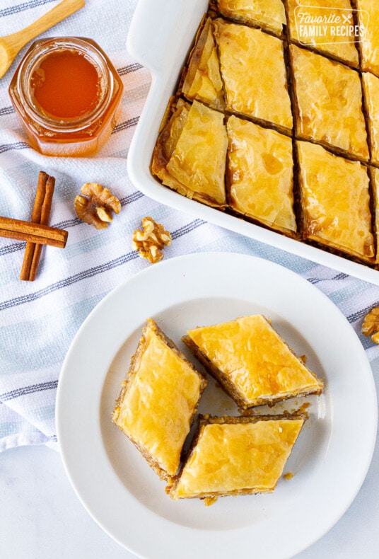 Top view of sliced Baklava on a plate and dish of Baklava.