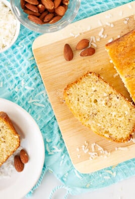 Sweet Coconut Bread slice on a plate next to a loaf.