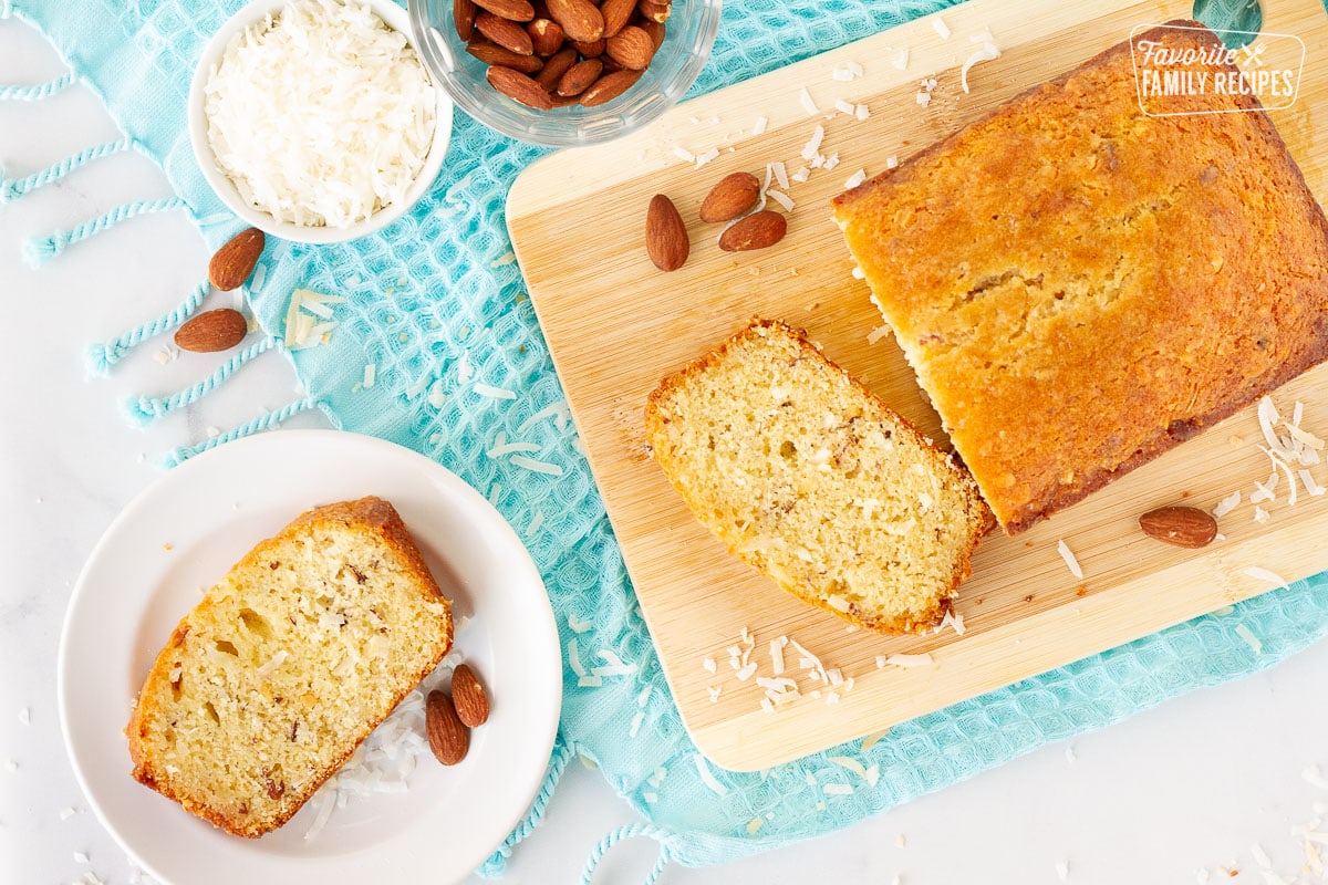 Sweet Coconut Bread slice on a plate next to a loaf.
