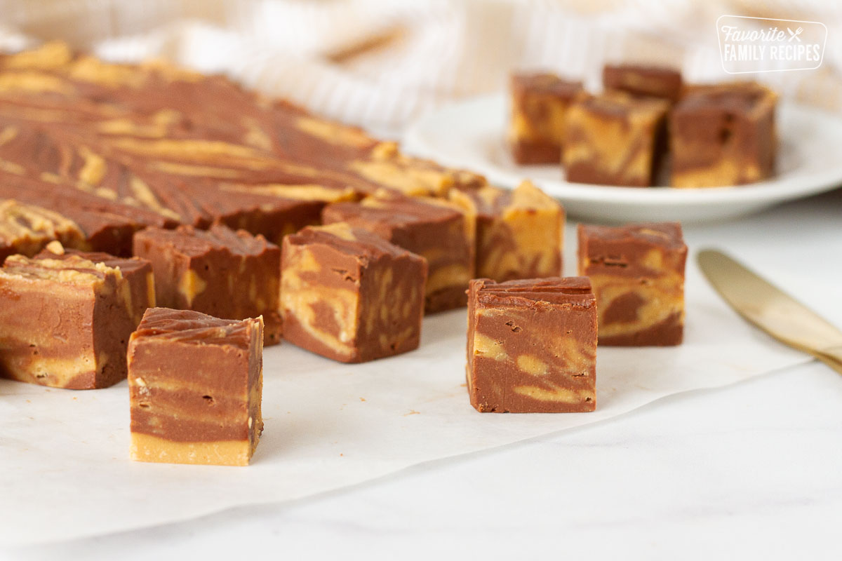 Chocolate Peanut Butter Fudge in cubes next to plate.