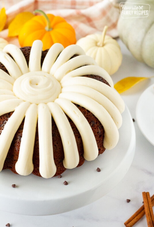 Side view of a Pumpkin Bundt Cake decorated with cream cheese frosting.