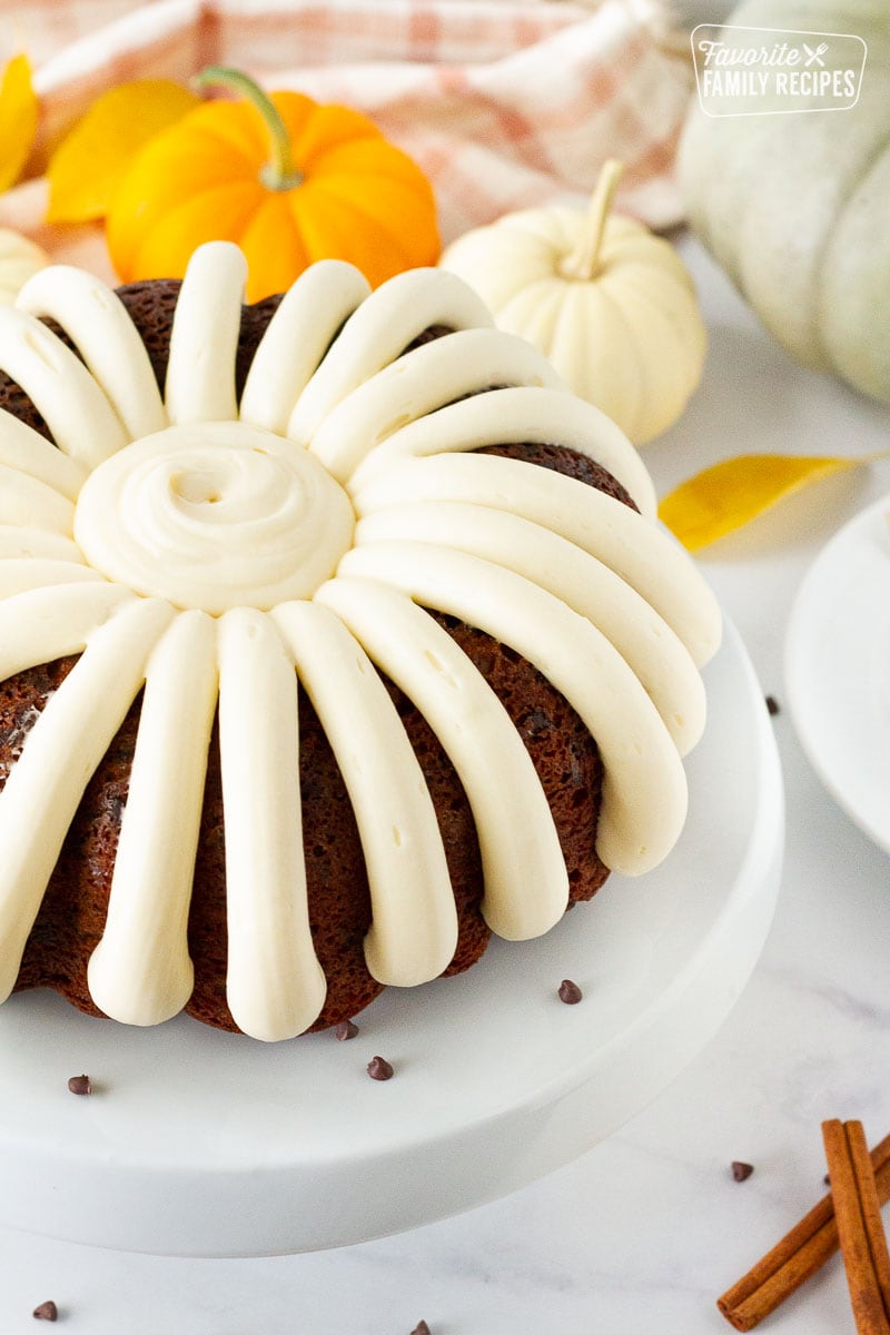 Side view of a Pumpkin Bundt Cake decorated with cream cheese frosting.