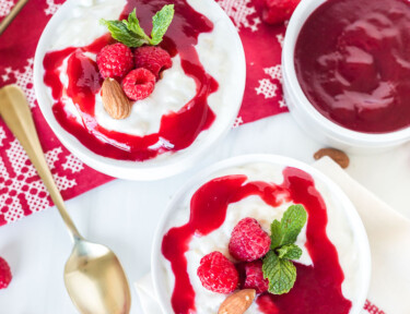 Danish Christmas rice pudding in two bowls with raspberry sauce on top