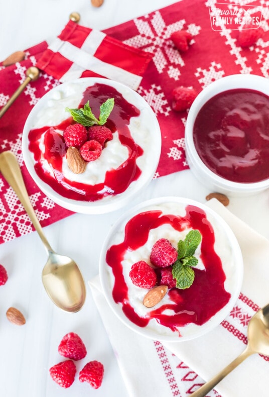 Danish Christmas rice pudding in two bowls with raspberry sauce on top