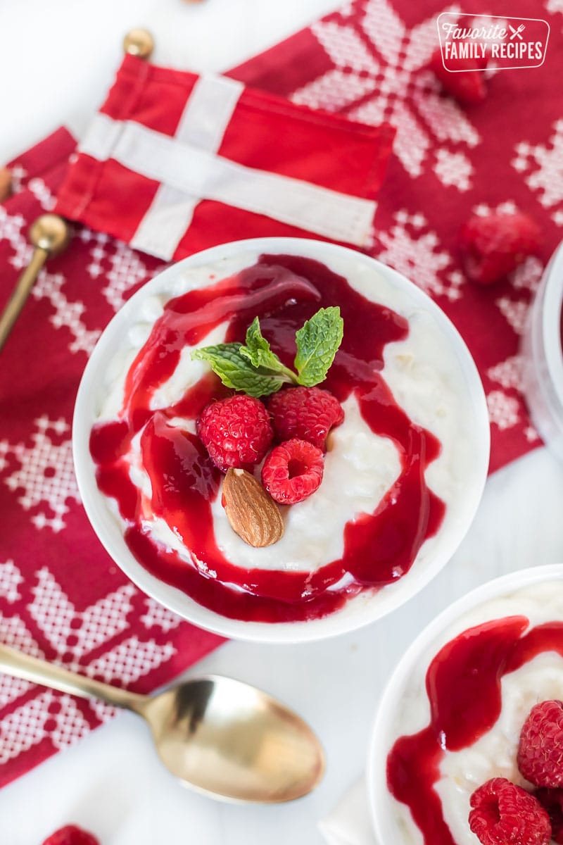 A bowl of risalamande topped with raspberries and mint