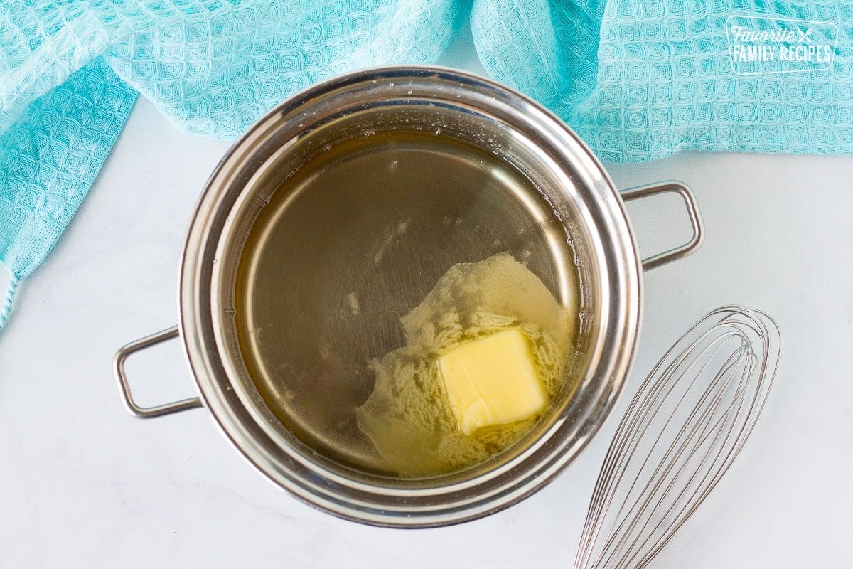 Pan of Sweet Coconut Bread glaze with melting butter.