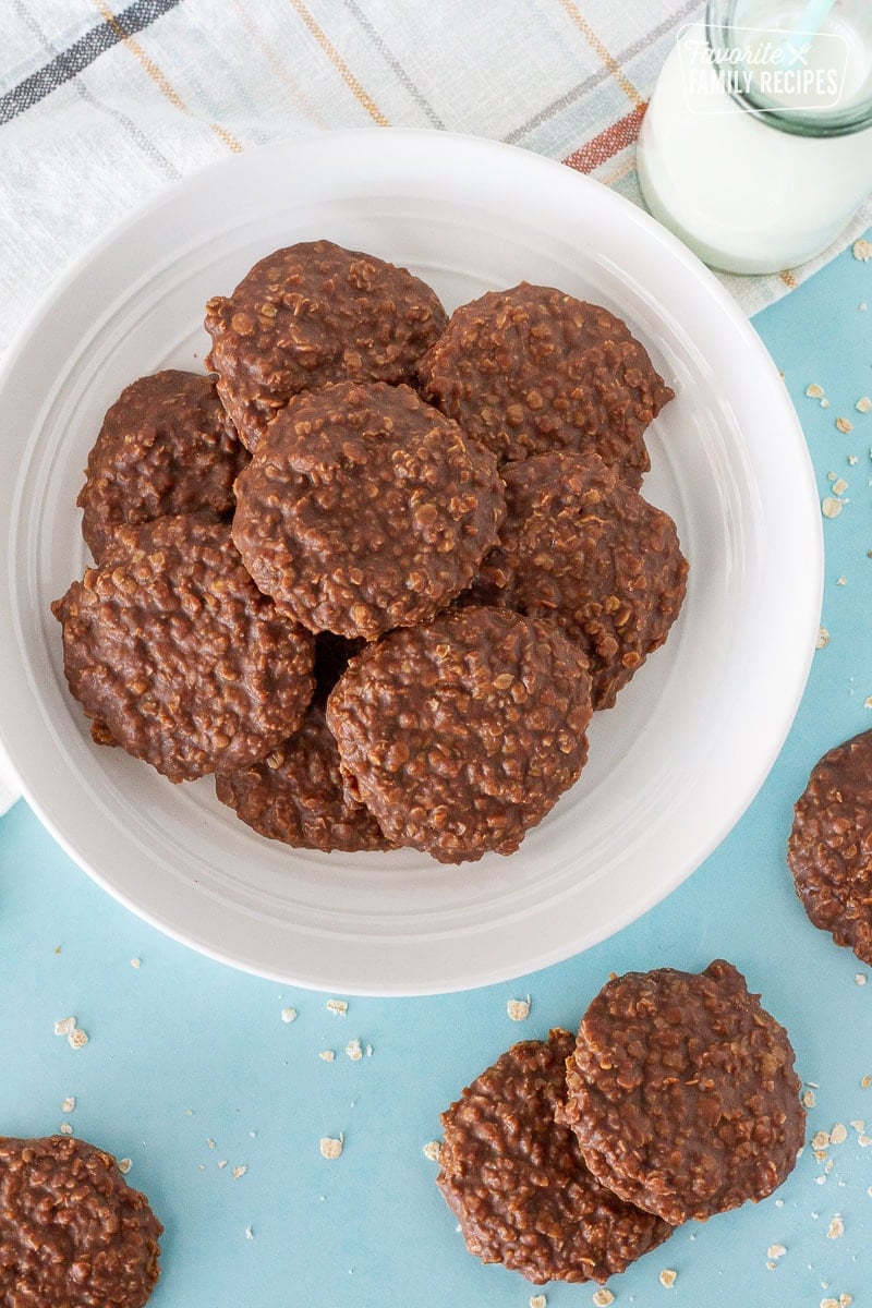 Plate of Easy No Bake Cookies next to a glass of milk and cookies on the table.