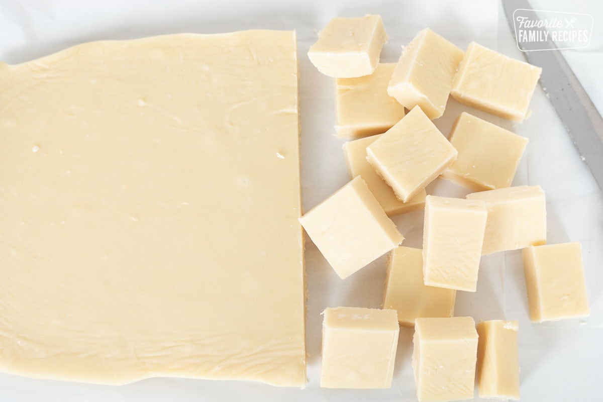 A block of fudge being cut into smaller pieces.