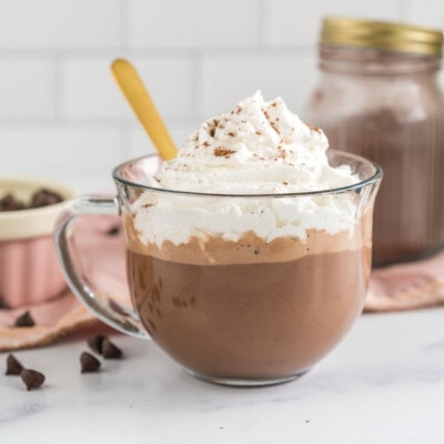 A mug of vegan hot chocolate topped with whipped cream