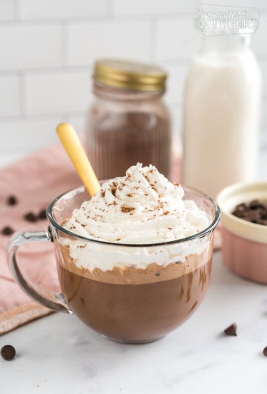 A mug of vegan hot chocolate topped with whipped cream