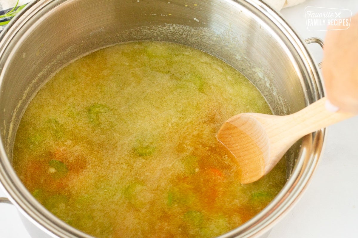 Pot of vegetables and broth for Homemade Chicken Noodle Soup.