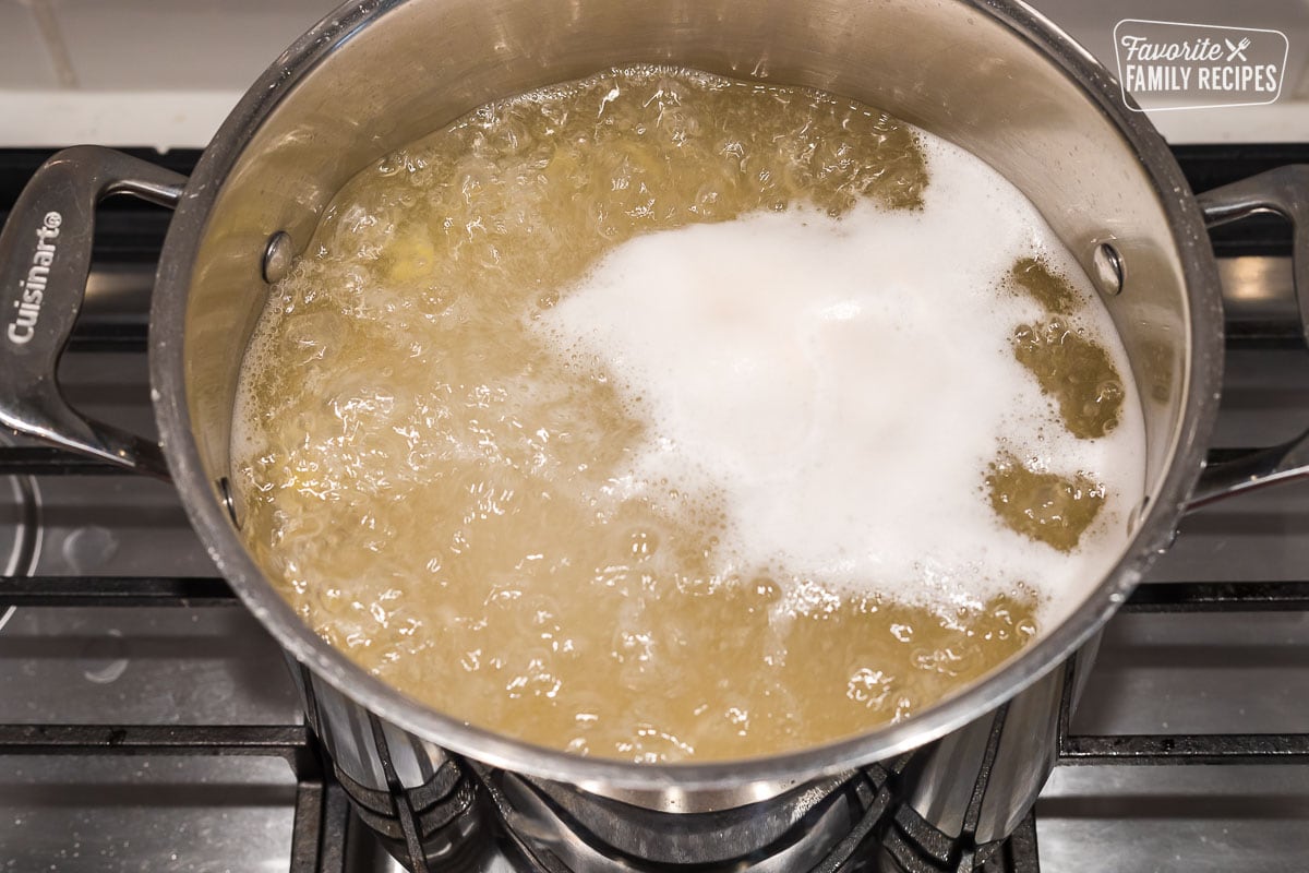 Macaroni being boiled in water in a large pot