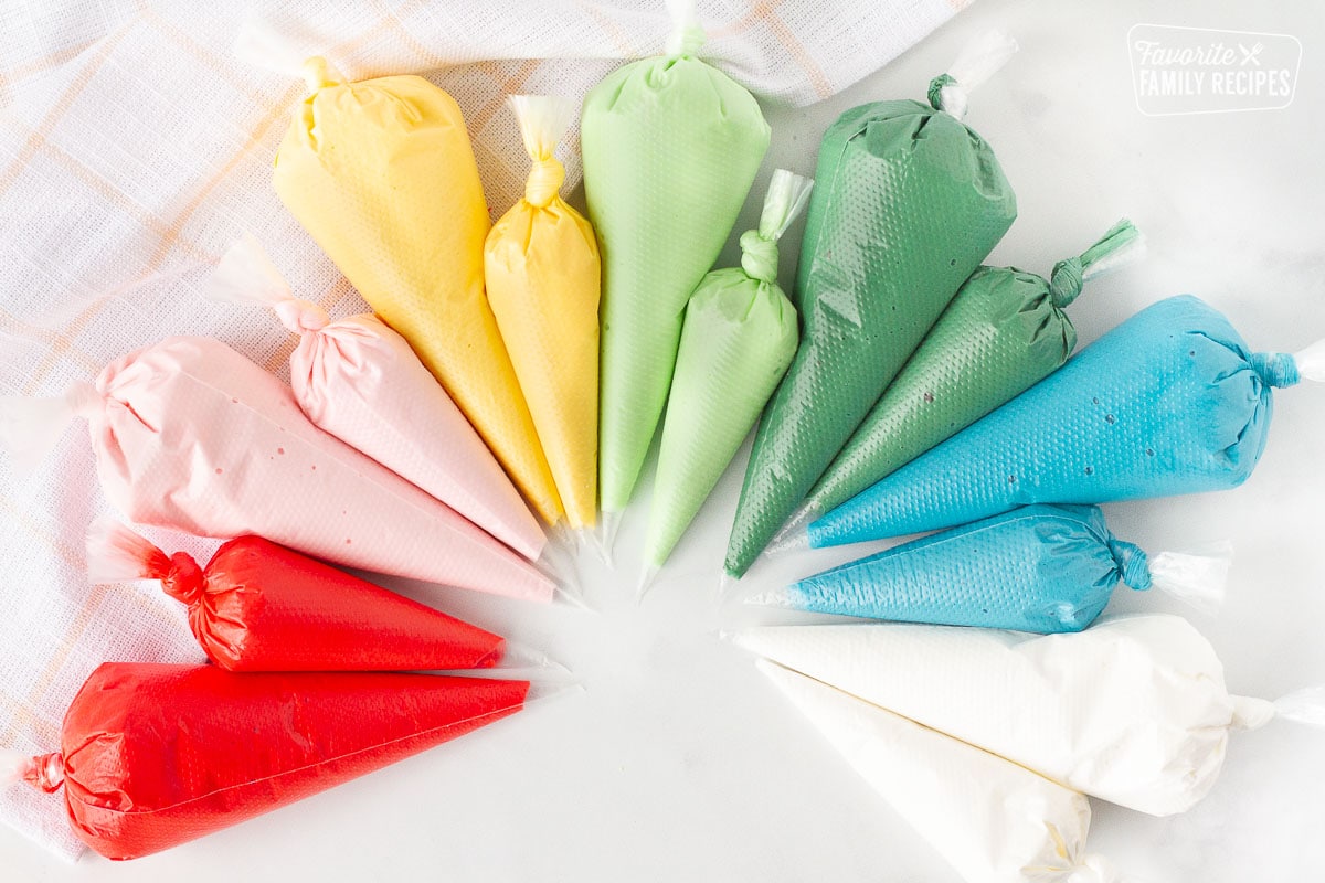 Red, pink, yellow, light green, dark green, blue and white bags of Royal Icing.
