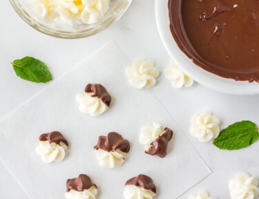 Chocolate dipped Butter Mints with Cream Cheese. Bowl of plain Butter Mints with Cream Cheese next to a bowl of melted chocolate.
