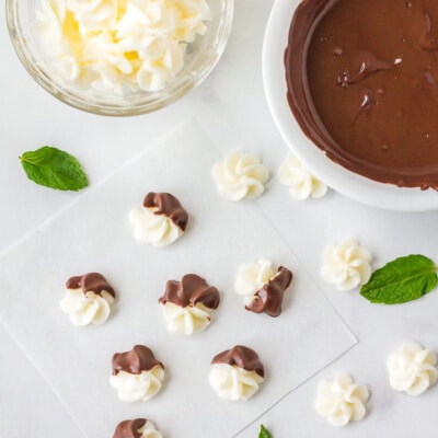 Chocolate dipped Butter Mints with Cream Cheese. Bowl of plain Butter Mints with Cream Cheese next to a bowl of melted chocolate.
