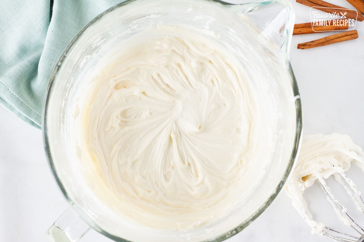 Mixing bowl with cream cheese frosting for Cinnamon Roll Cake topping.