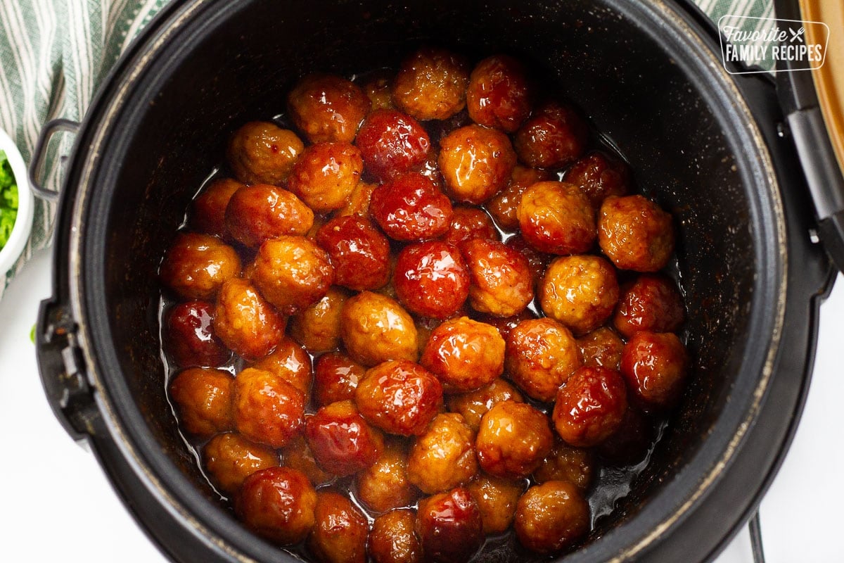 Slow cooker with fully cooked Cocktail Meatballs.