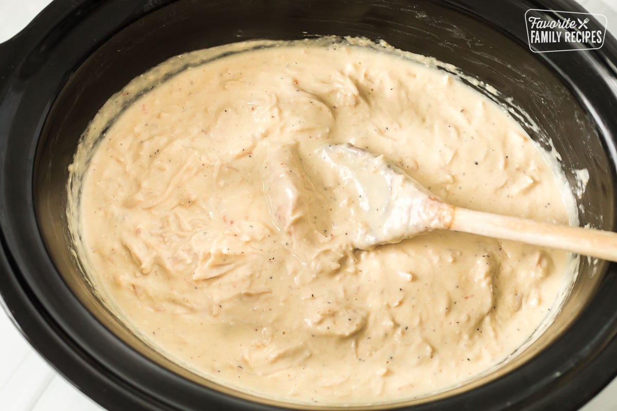 A Crockpot with creamy chicken Alfredo
