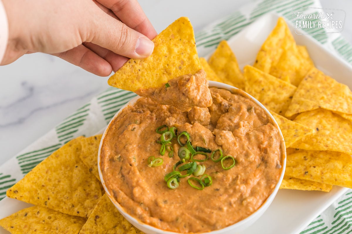 A tortilla chip dipped into crockpot taco dip