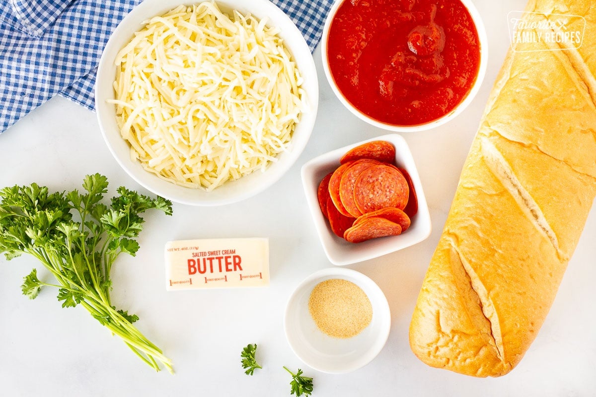 French bread, sauce, mozzarella cheese, pepperoni, garlic powder, butter and fresh parsley to make French Bread Pizza.