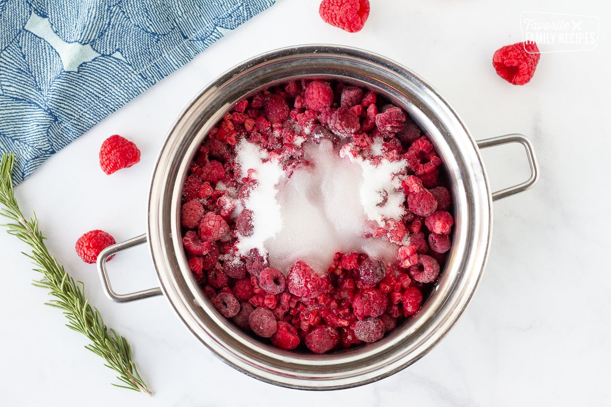 Pot of frozen raspberries, sugar and water for Raspberry Cheesecake sauce.