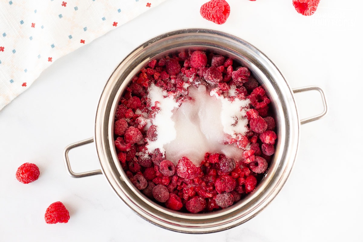 Pot of frozen raspberries, sugar and water for Raspberry sauce.