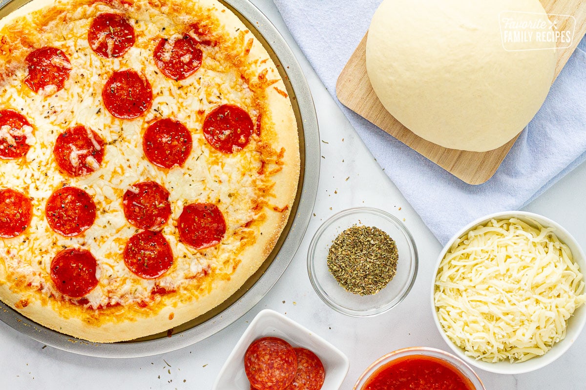 Baked whole Pepperoni Pizza with Homemade dough. Toppings on the side.