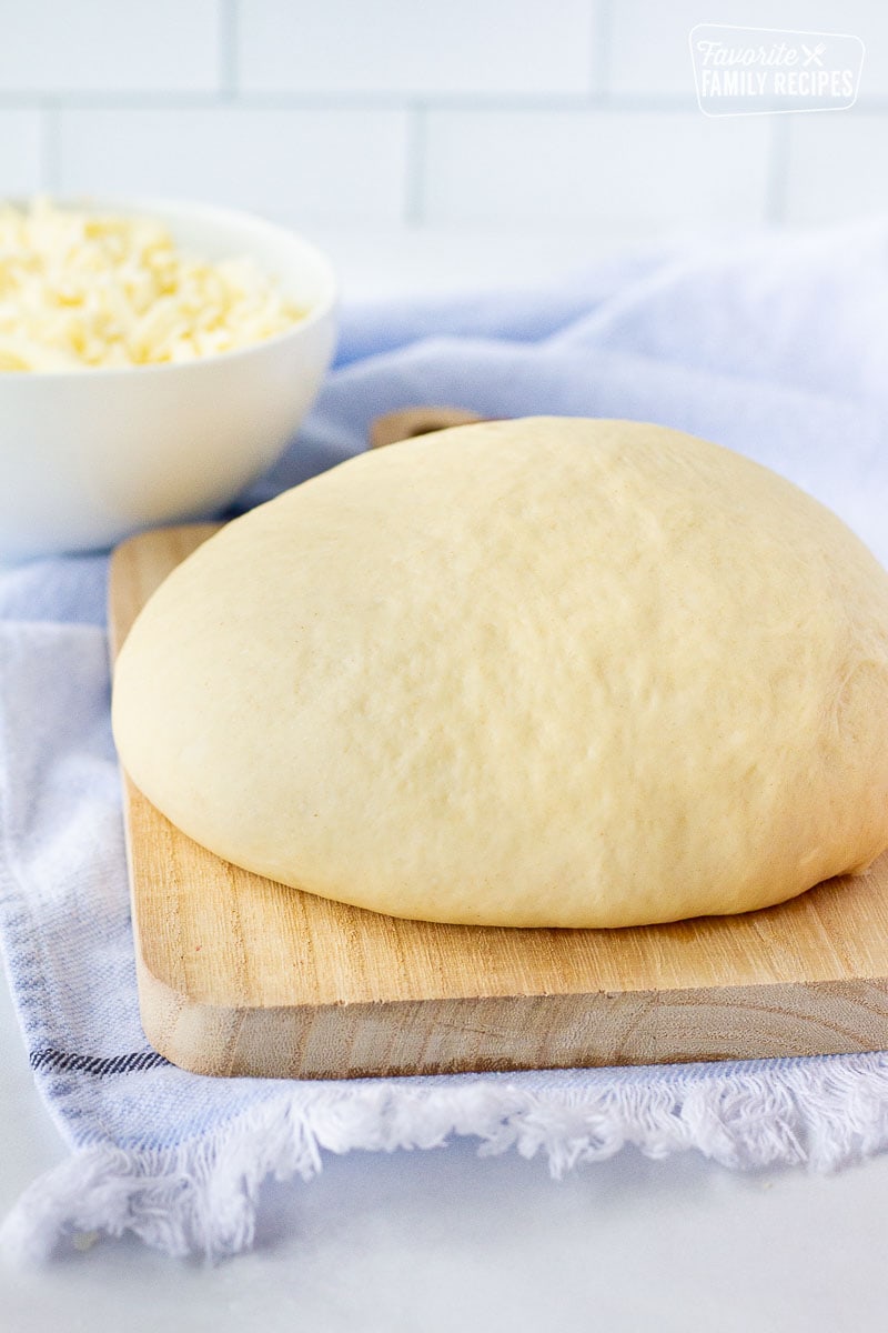 Close up of a large Ball of Homemade Pizza Dough on a board.