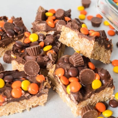 Peanut Butter Rice Krispie Treats cut into servings with Reeses pieces sprinkled over the top