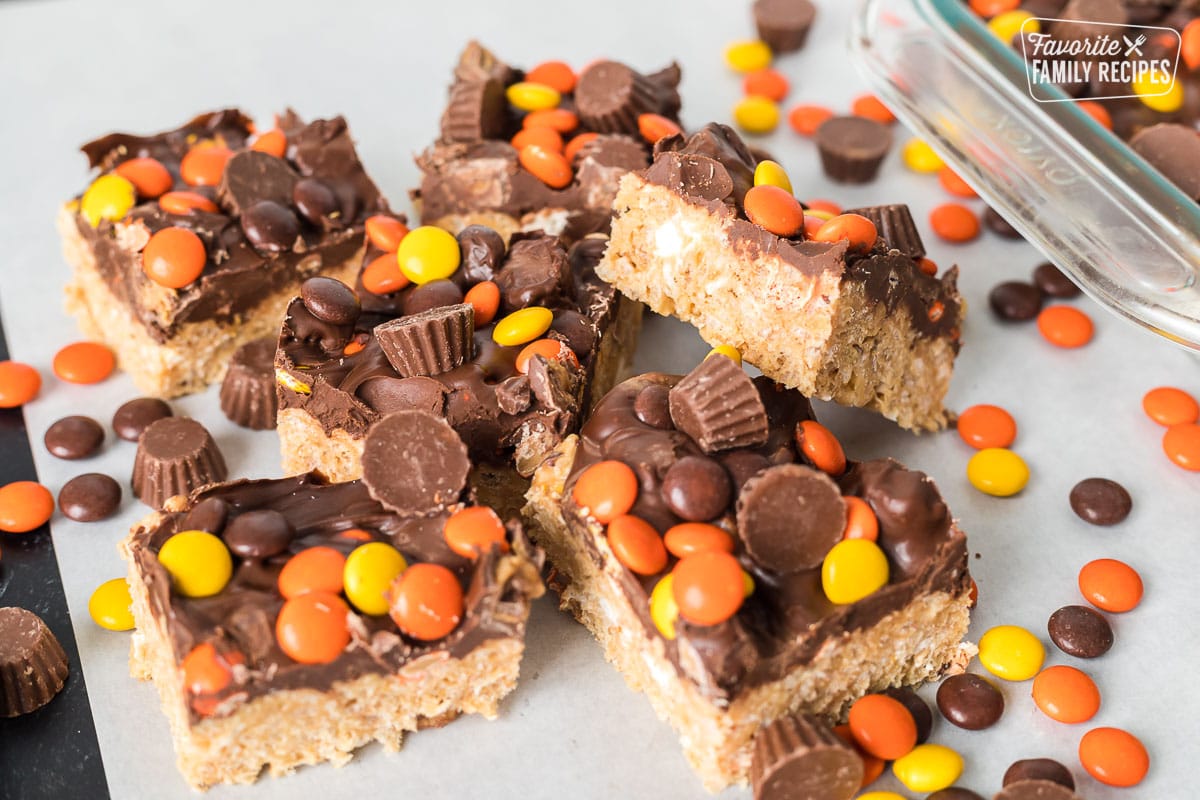 Peanut Butter Rice Krispie Treats cut into servings with Reeses pieces sprinkled over the top