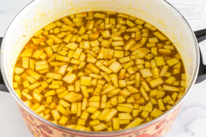 Mulligatawny soup broth with apples, chicken, and rice added