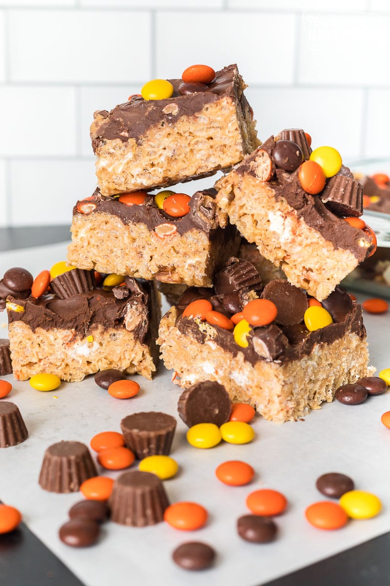 Peanut Butter Rice Krispie Treats stacked on a table top.