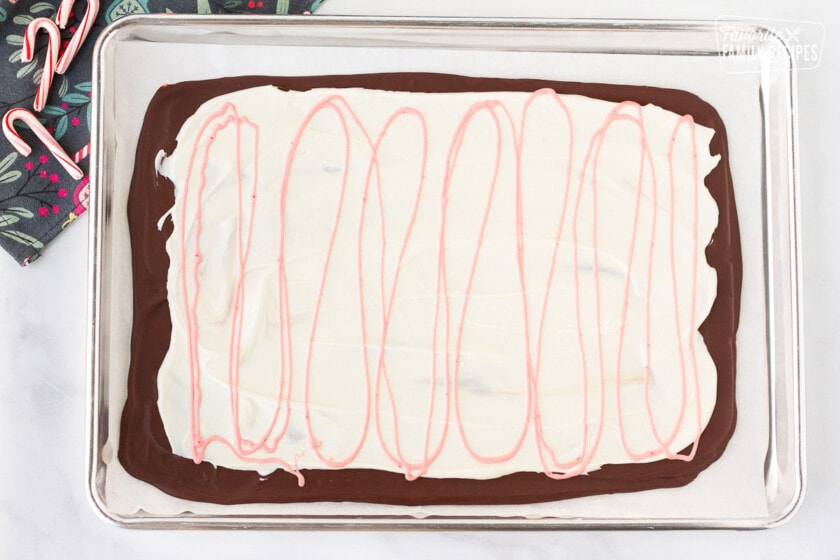 Sheet of dark chocolate and white chocolate with a pink swirl for Peppermint Bark.