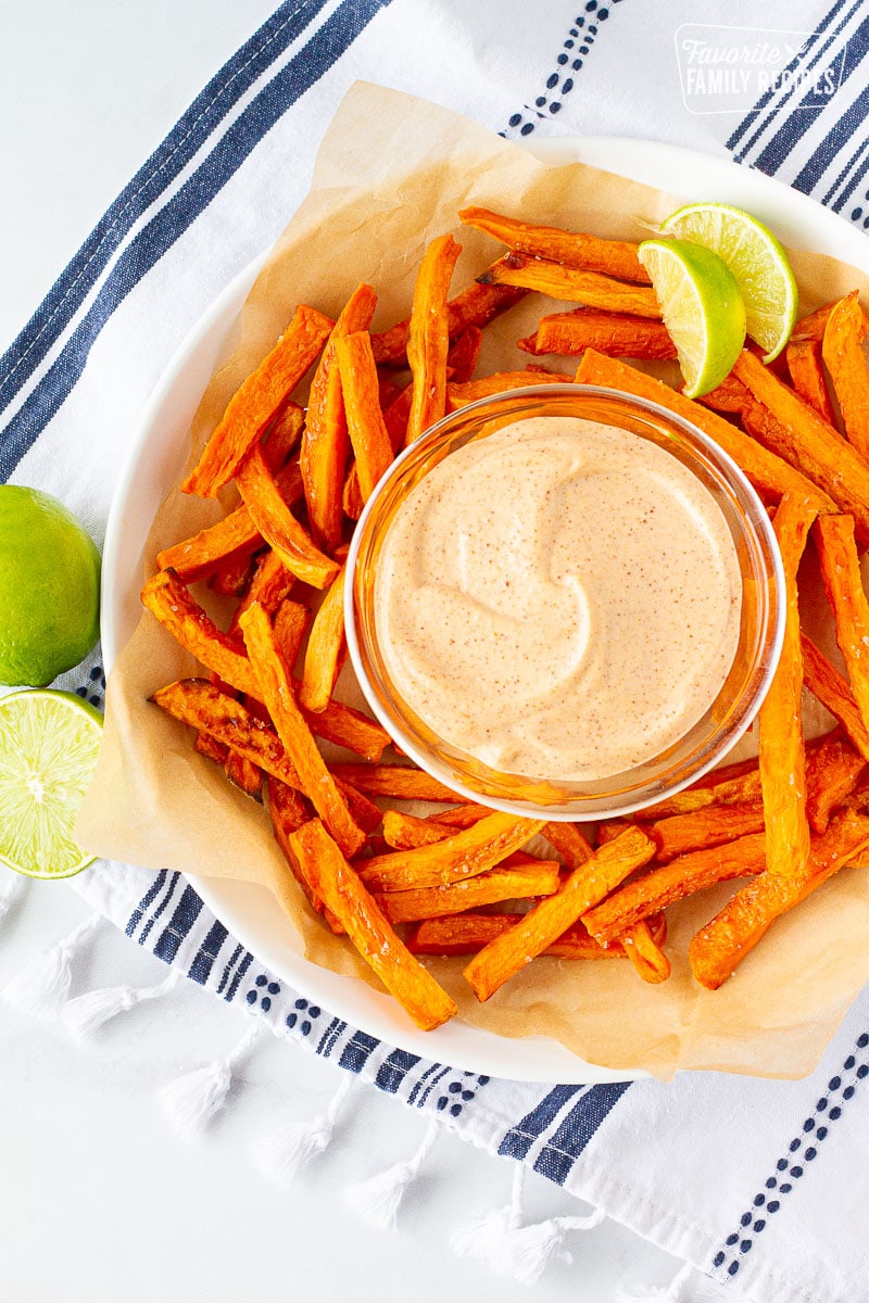 Plate of Dipping sauce surrounded by sweet potato fries.