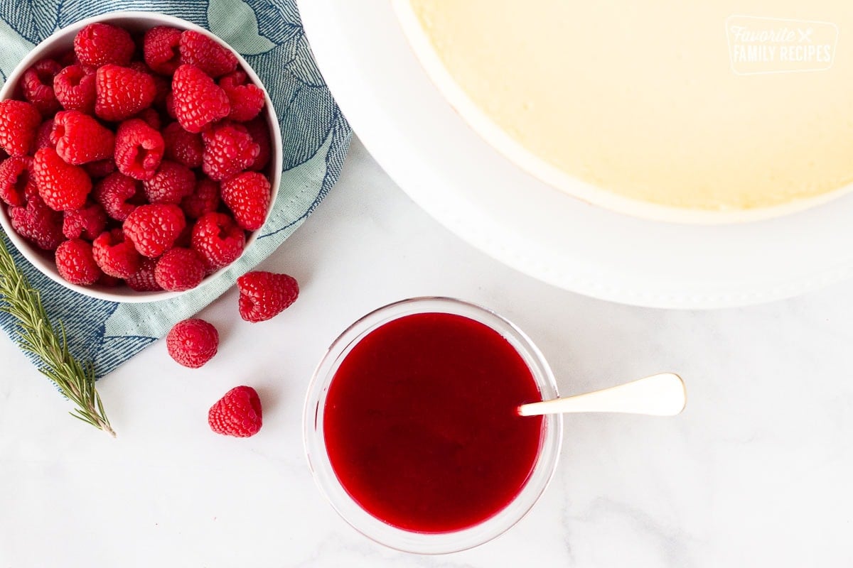 Plain cheesecake, raspberry sauce and fresh raspberries.