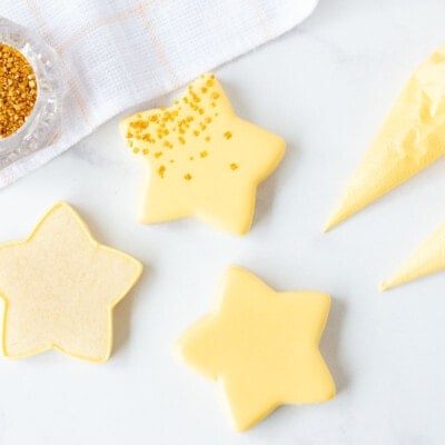 Three star shaped cookies with Royal Icing and Flood Icing.