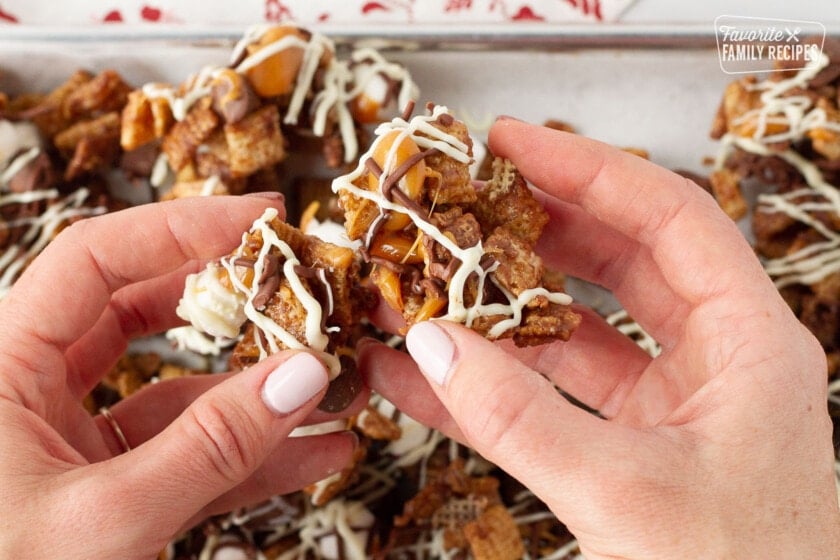 Hands separating Sweet Chex Mix.