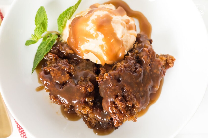 A bowl of sticky toffee pudding with mint