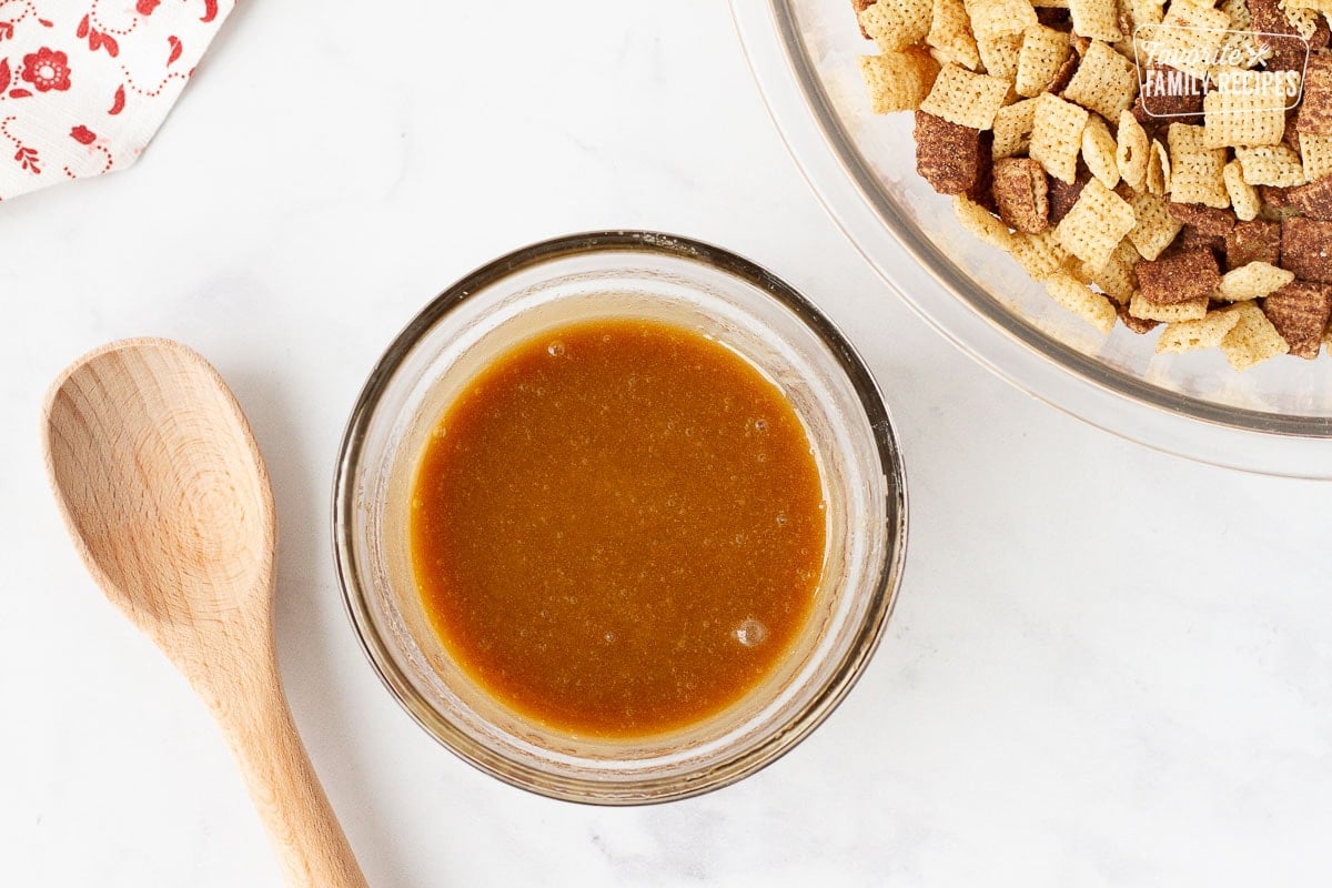 Sugar butter mixture in a bowl next to bowl of Chex for Sweet Chex Mix.