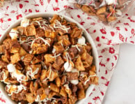Top view of Sweet Chex Mix in a bowl next to a bag of Sweet Chex Mix.