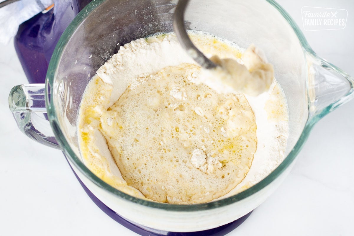 Mixing bowl with dry and wet ingredients for Homemade Pizza Dough.