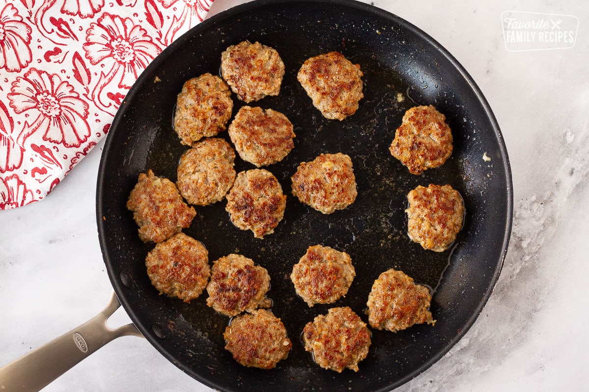 Browned and cooked Frikadeller (Danish Meatballs) in a skillet.