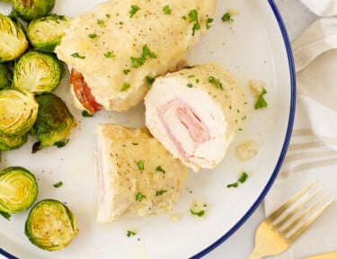 Instant Pot Chicken Cordon Bleu cut in half next to a whole Chicken Cordon Bleu.