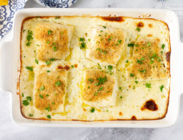 Baking dish with five fillets of Baked Cod in Cream Sauce.