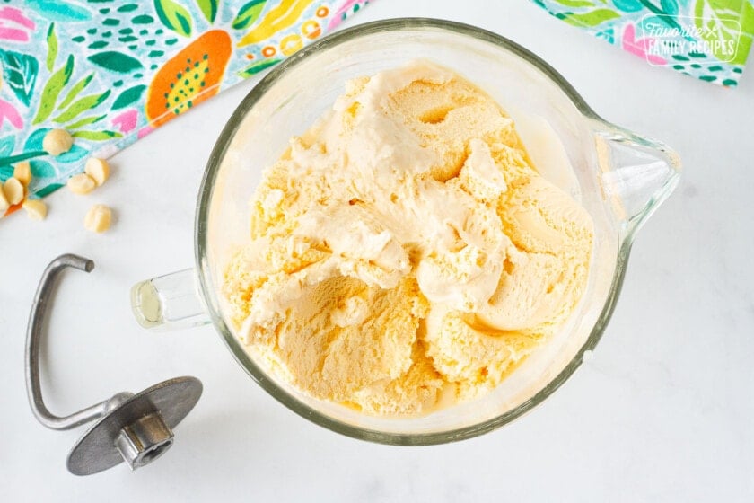 French vanilla ice cream scooped into a mixing bowl next to a dough hook for Duke's Hula Pie.