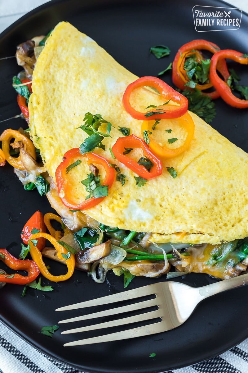 A top view of a vegetable omelette with sautéed peppers on the top