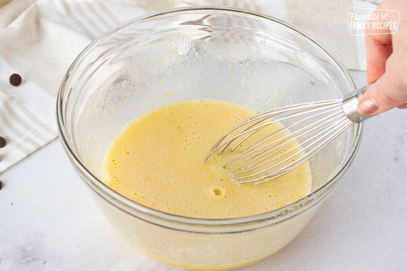 Bowl with eggs and sugar being whisked for Carnival Cruise Melting Chocolate Cake.