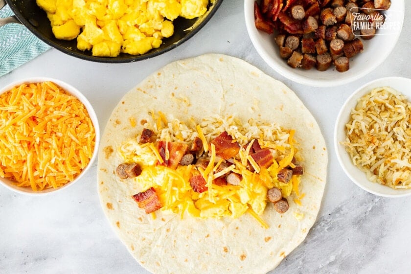 A tortilla with breakfast burrito filling line over the top