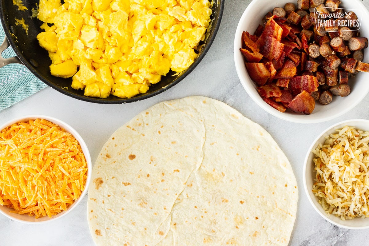 A tortilla with fixings to make a breakfast burrito